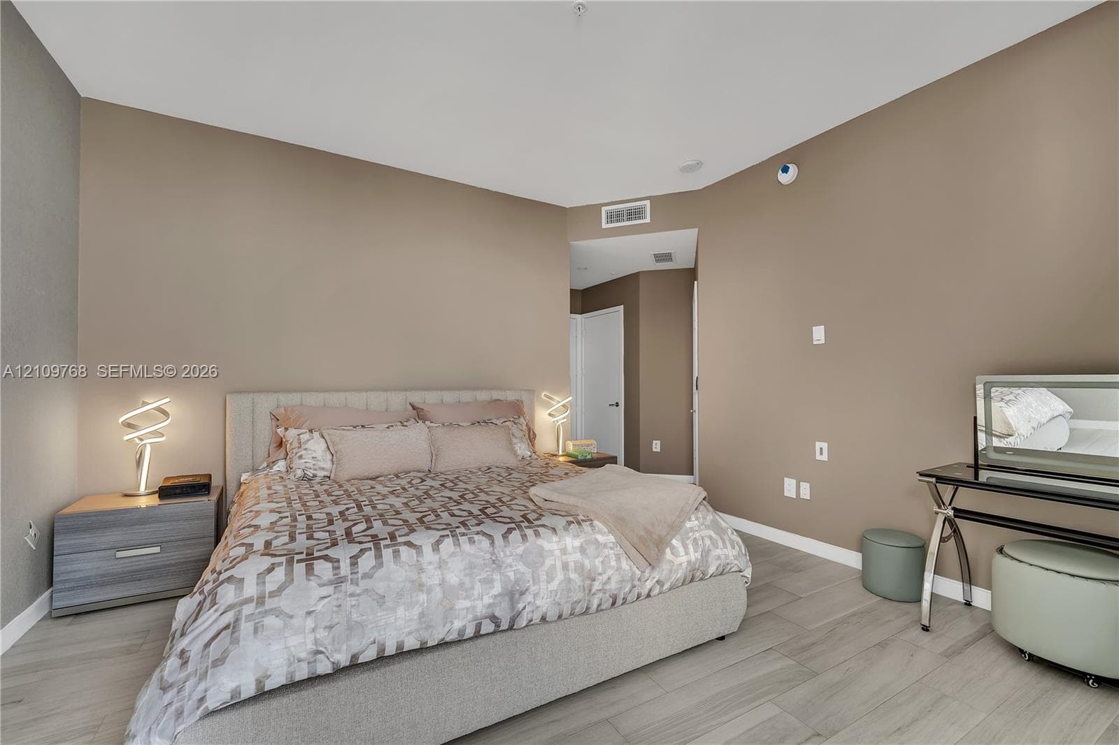 Neutral-toned interior featuring wood-finish flooring, recessed ceiling lighting, and crisp white trim