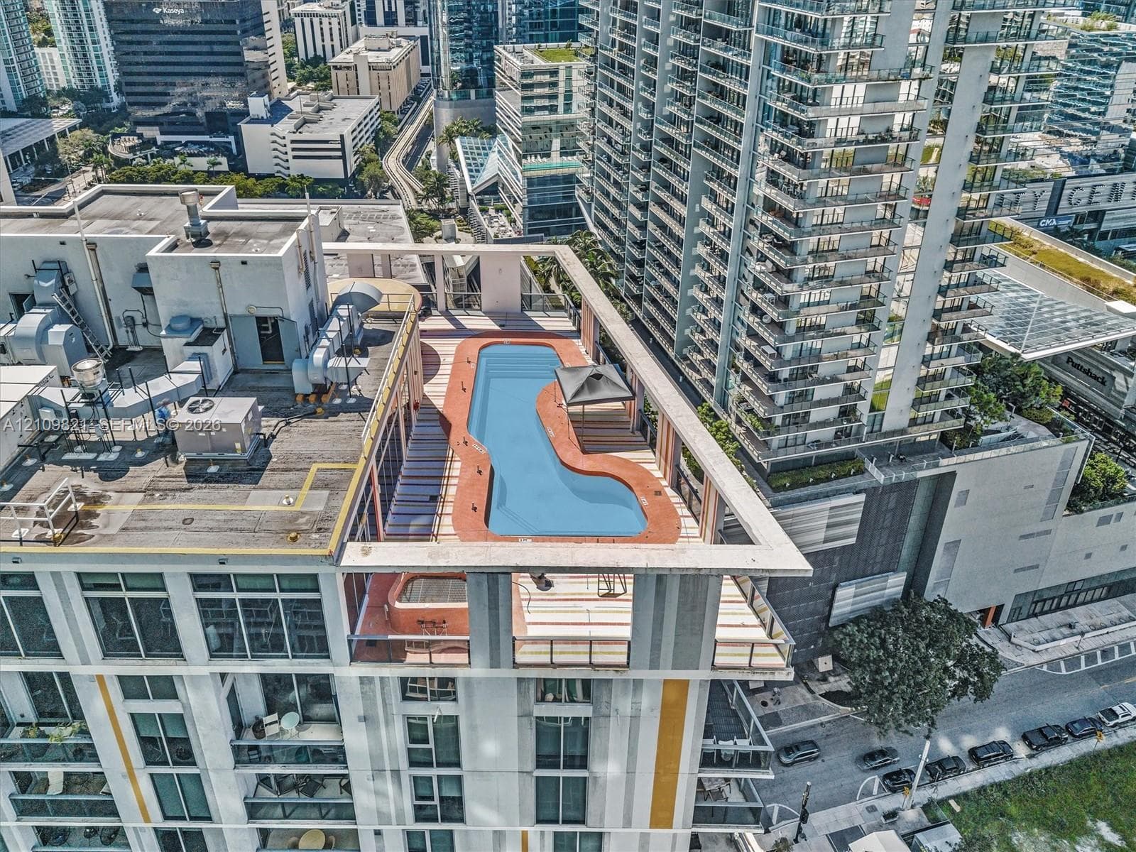 Rooftop terrace featuring an in-ground pool, elevated sun deck, and integrated shaded structure
