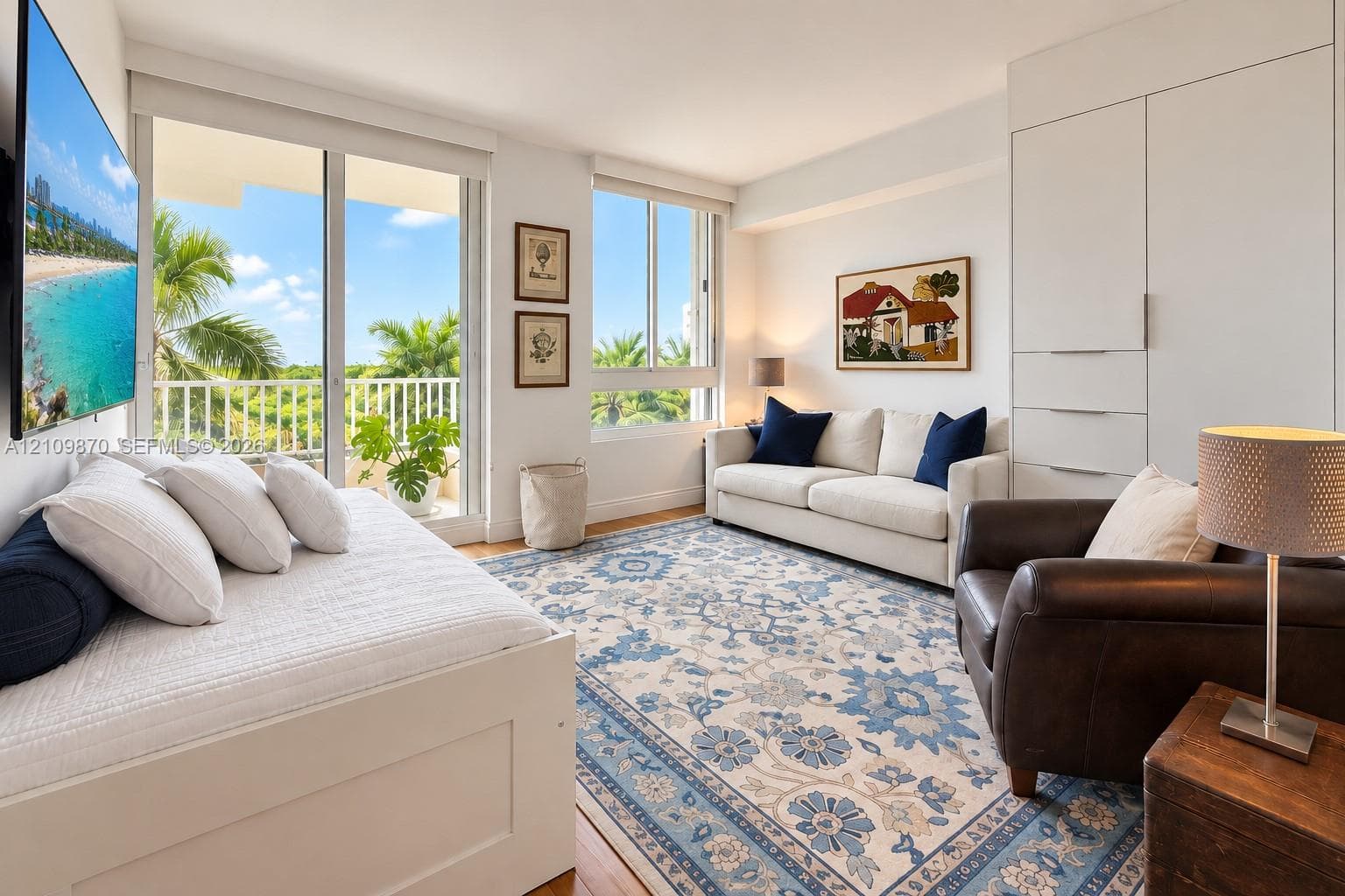 Living area featuring floor-to-ceiling windows, sliding glass door access to an exterior balcony, built-in floor-to-ceiling cabinetry, and light-toned wood-finish flooring