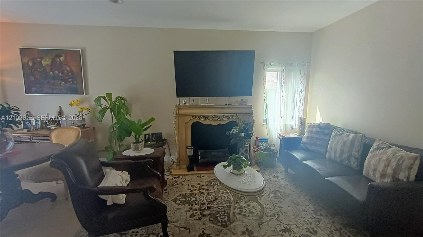 Ornate fireplace mantle with decorative carved detailing and recessed firebox