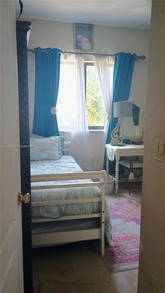 Single window with horizontal blinds and a dark-finished door featuring decorative molding