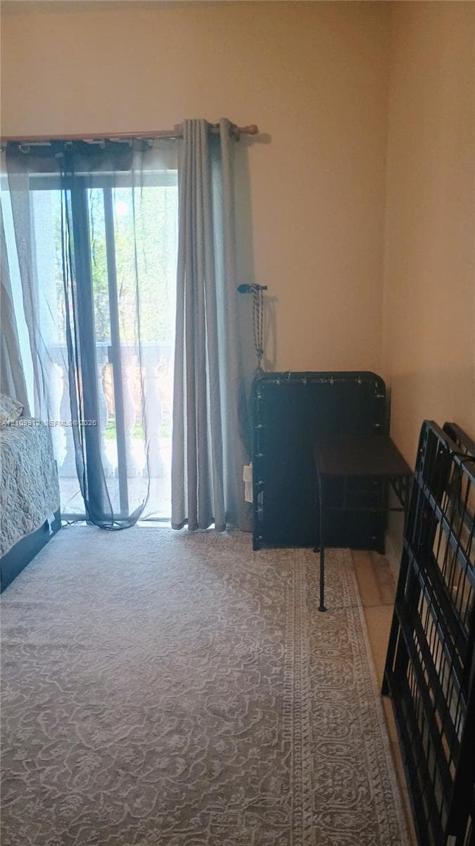 Sliding glass door with horizontal rod and exterior access