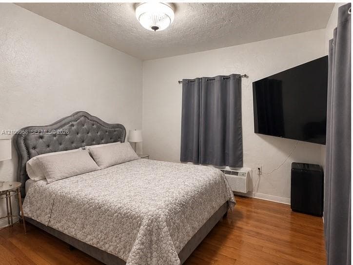 Wood-finish flooring, wall-mounted heating and cooling unit, and flush-mount ceiling lighting