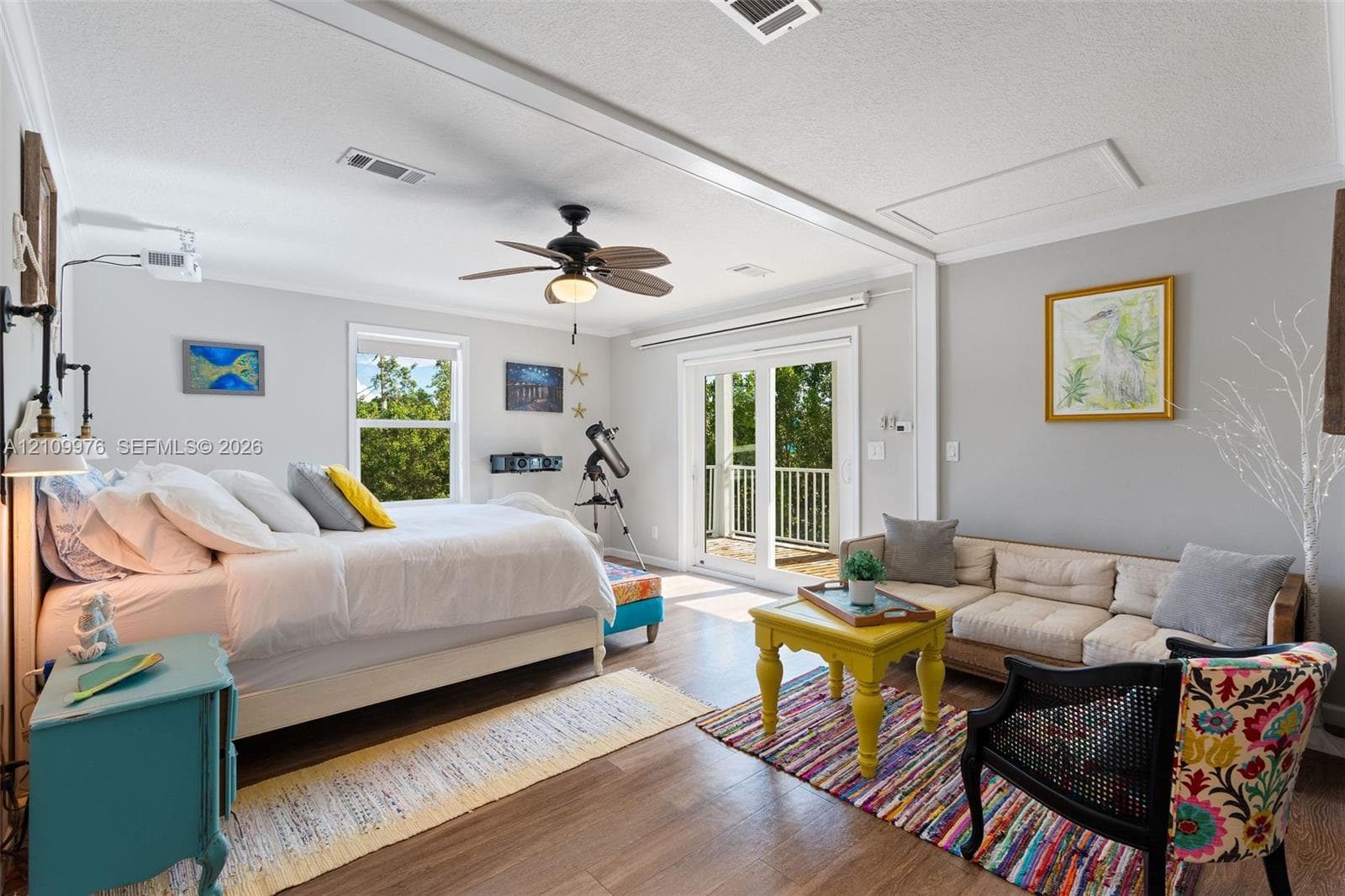 Spacious interior featuring wood-finish flooring, recessed lighting, a ceiling fan, and sliding glass doors with direct access to an exterior balcony