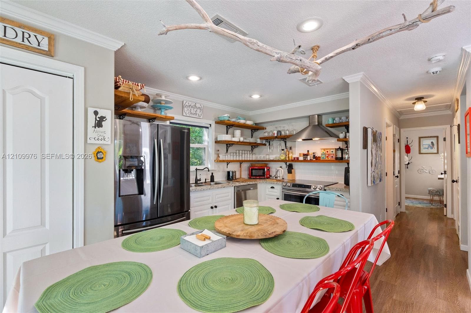Kitchen featuring white cabinetry, stone-finish countertops, stainless steel appliances, open shelving, and recessed lighting