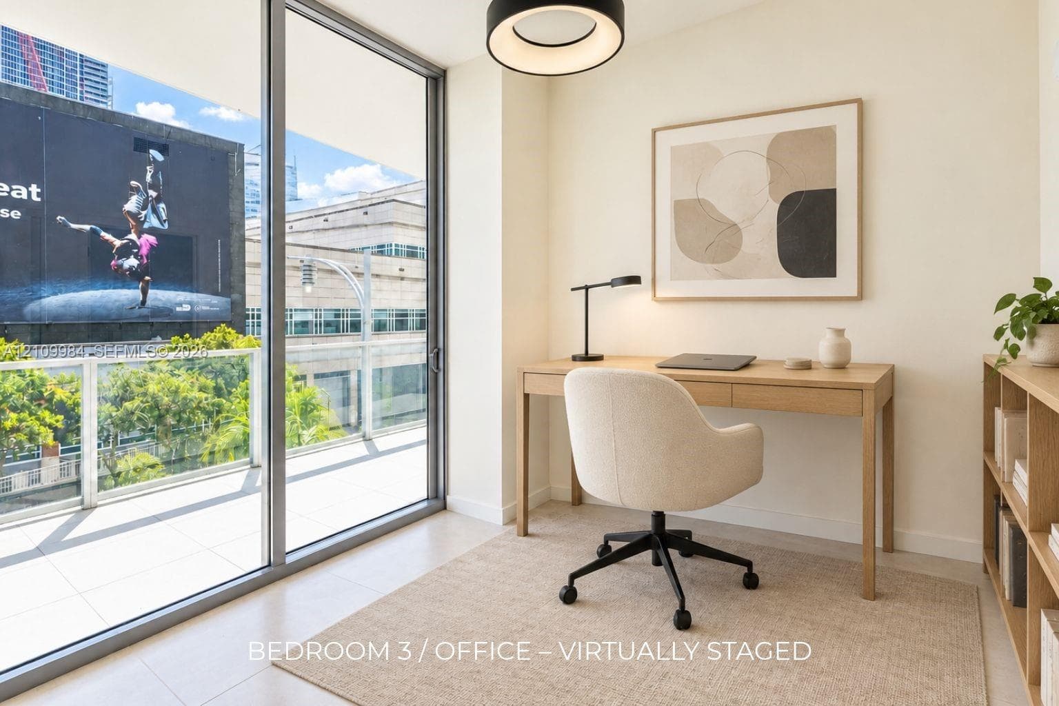 Floor-to-ceiling sliding glass door, private balcony with metal railing, neutral tile flooring, and circular modern pendant light fixture