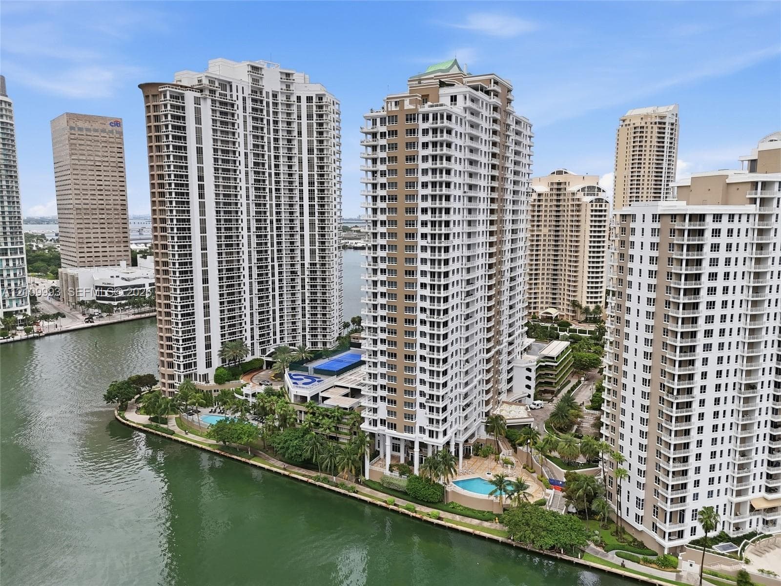 High-rise residential towers featuring private balconies, integrated swimming pools, and extensive waterfront frontage