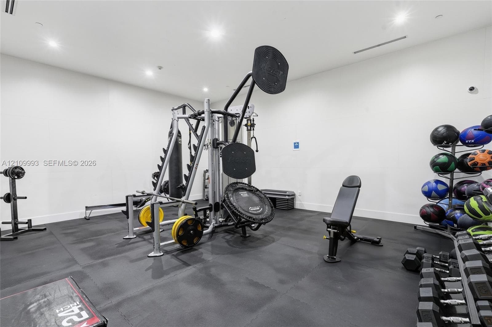 Exercise room featuring recessed ceiling lighting and durable rubberized floor surfacing