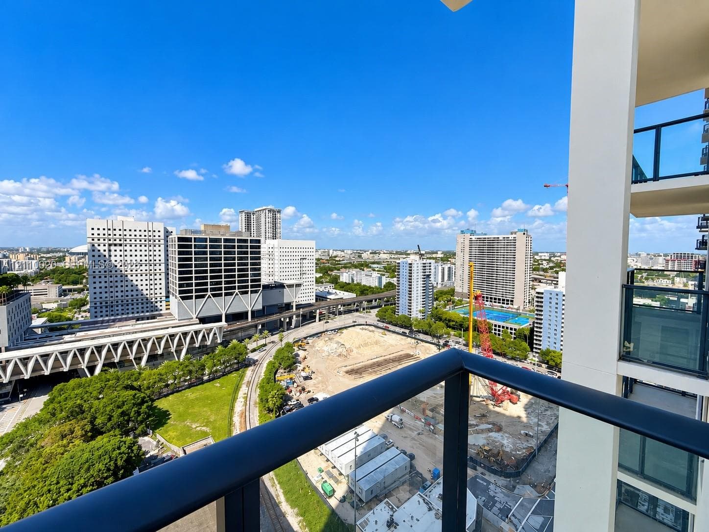 Elevated balcony featuring dark metal railings and integrated glass panels