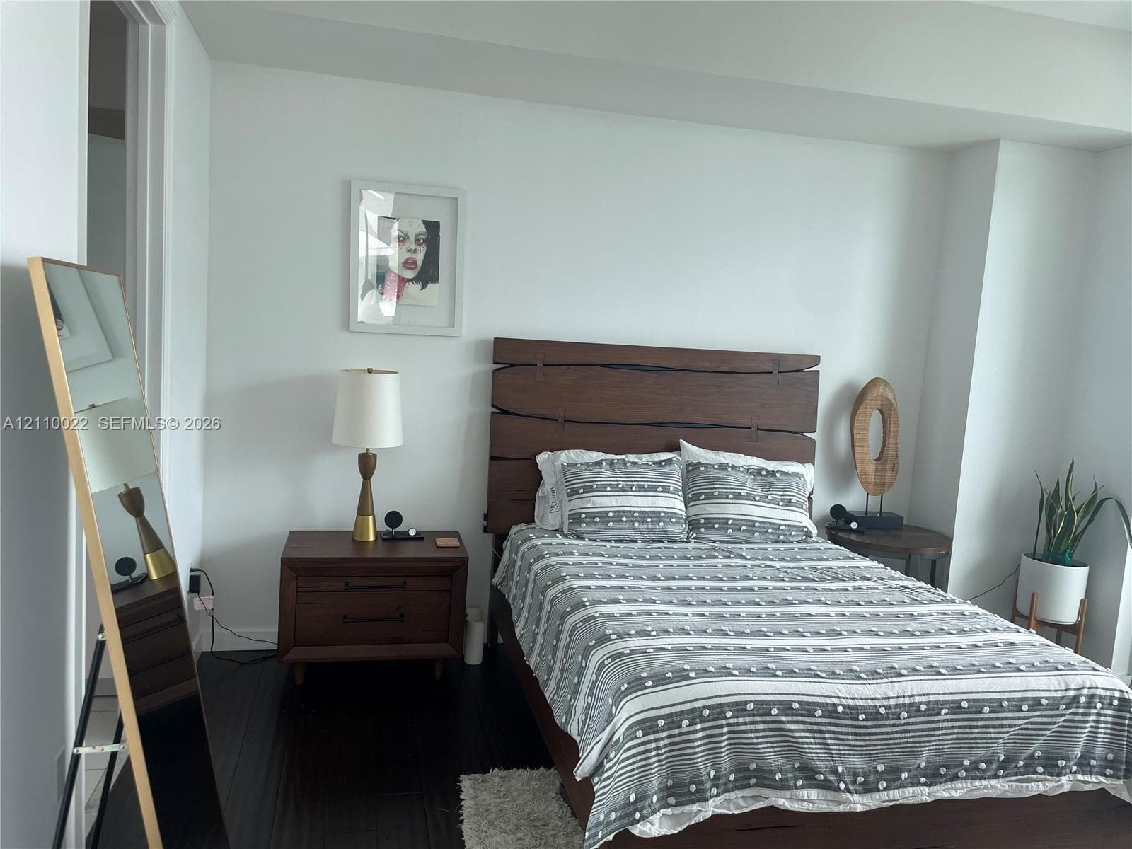 Dark wood-finish flooring and neutral wall paint