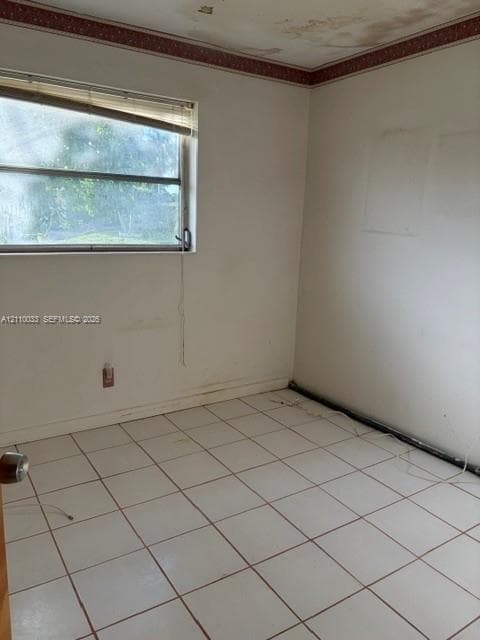 Interior space featuring white square tile flooring and a horizontal sliding window