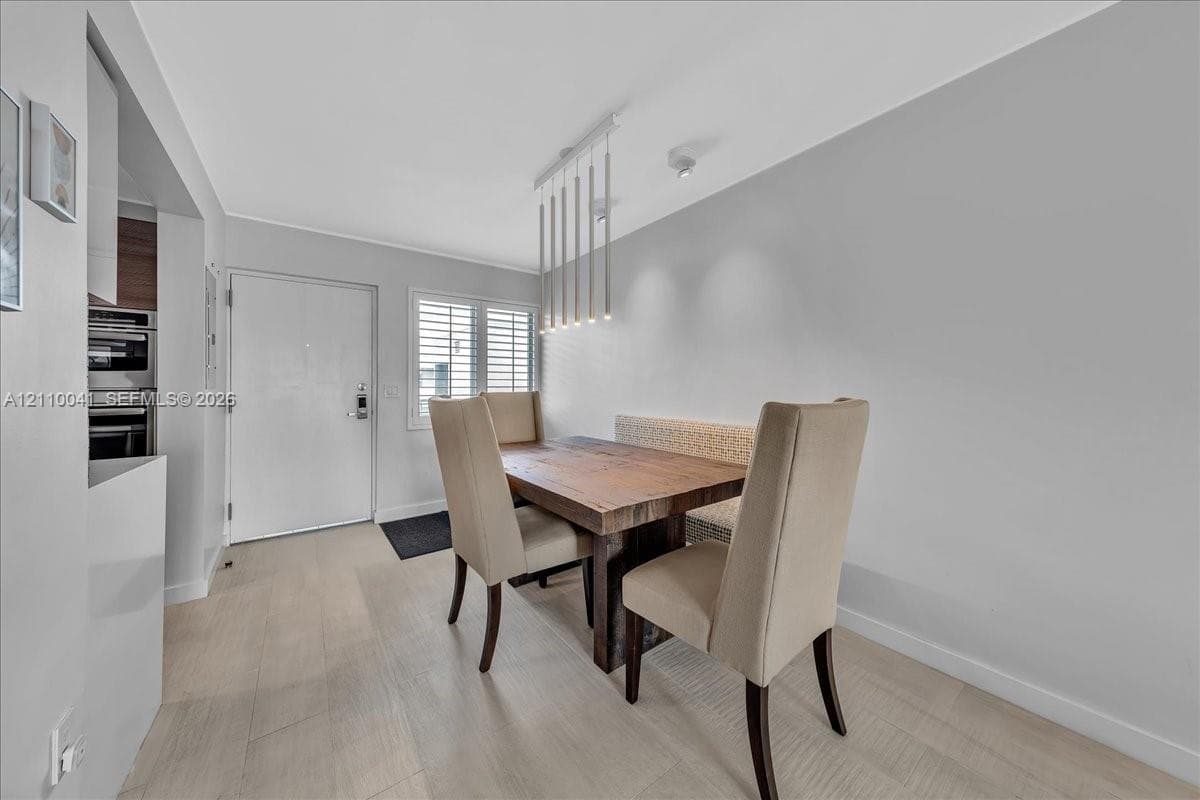 Wood-finish flooring, multi-pendant linear light fixture, and window shutters