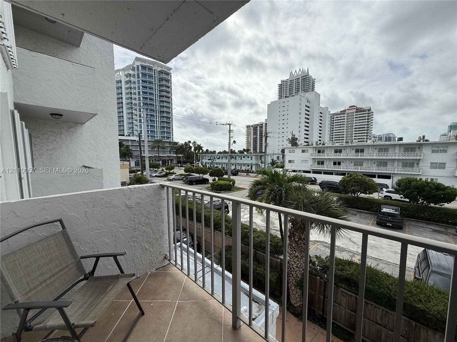Private balcony featuring a metal railing and tile flooring