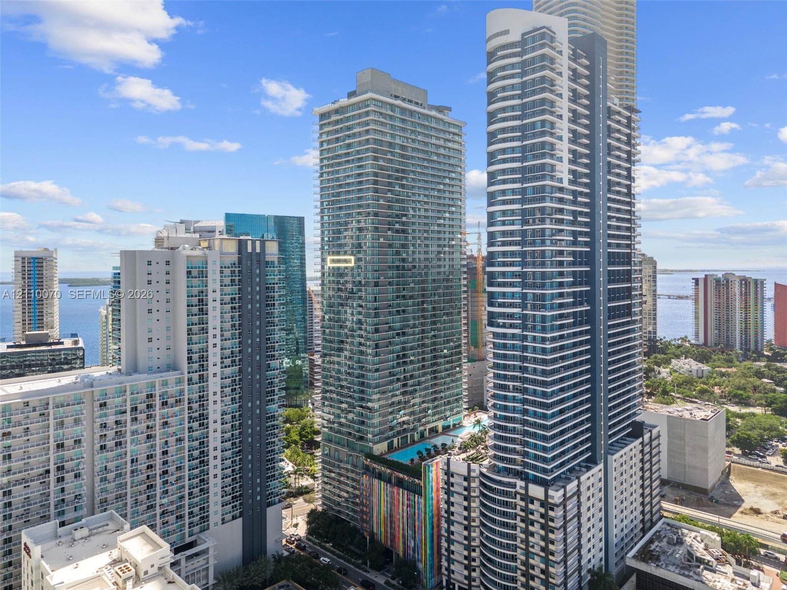 High-rise architecture featuring serrated glass-railed balconies and floor-to-ceiling windows