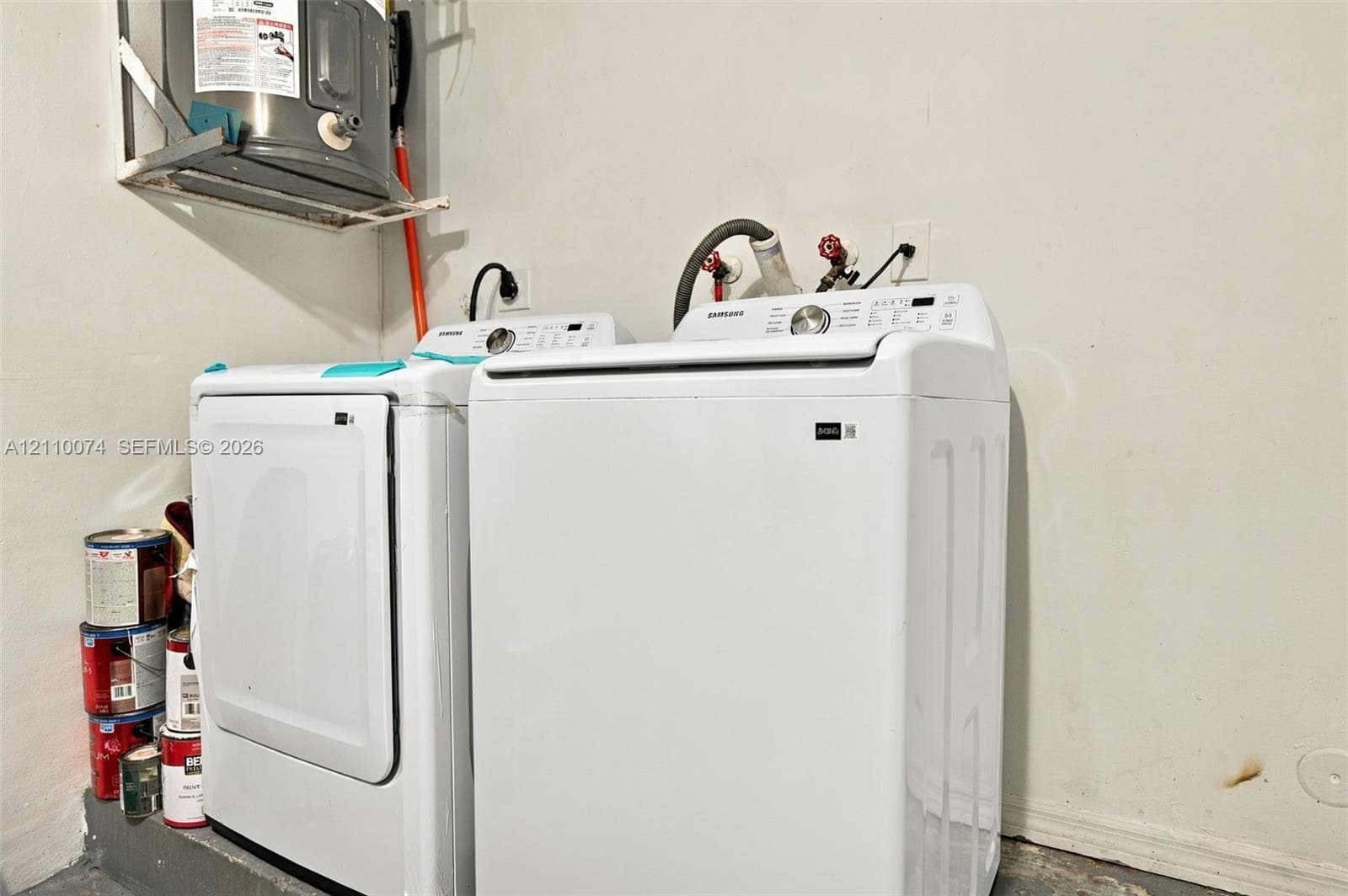 Laundry area featuring a wall-mounted water heater and dedicated appliance hookups