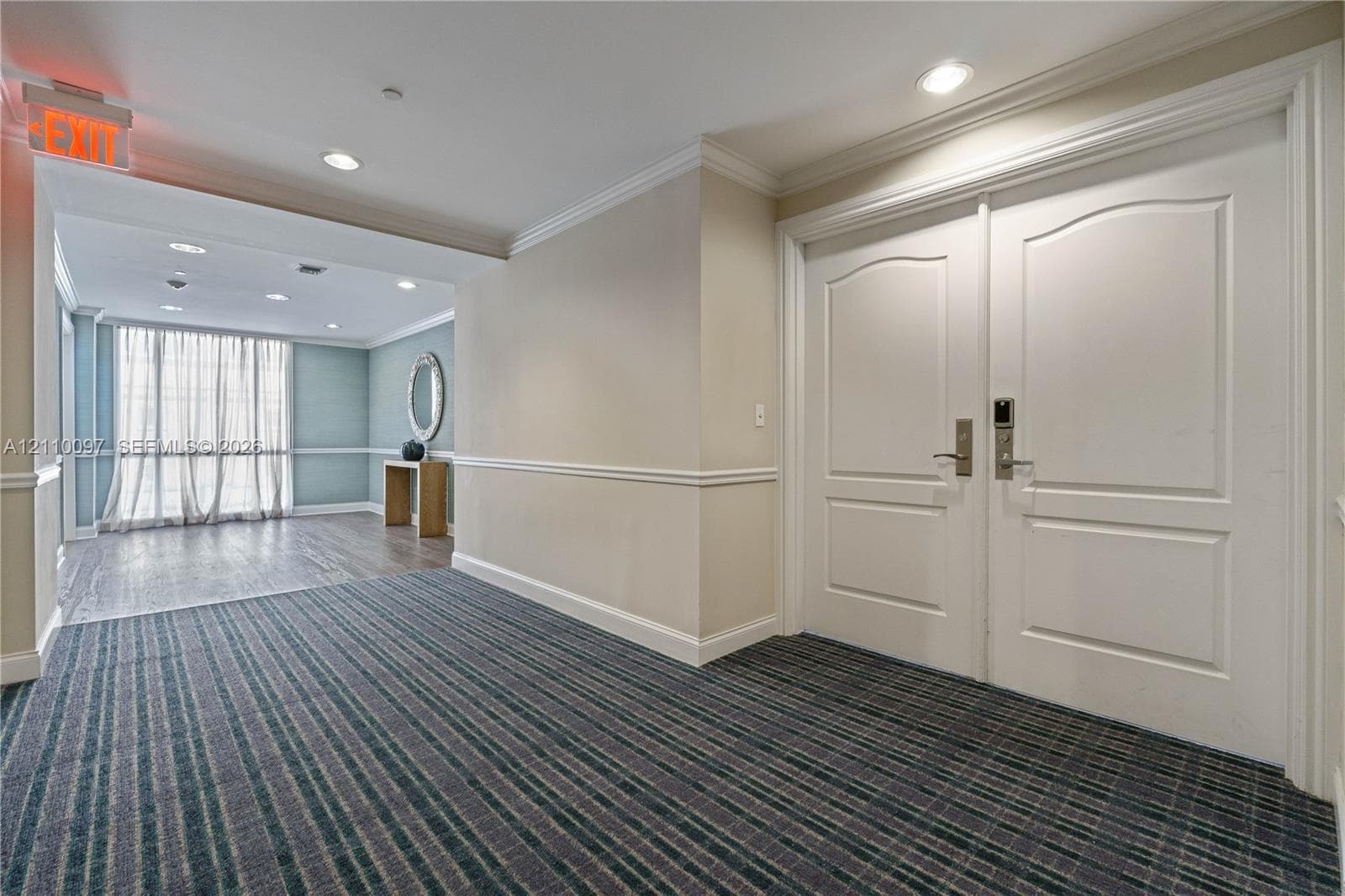 Double-door entry featuring paneled millwork, crown molding, and recessed lighting