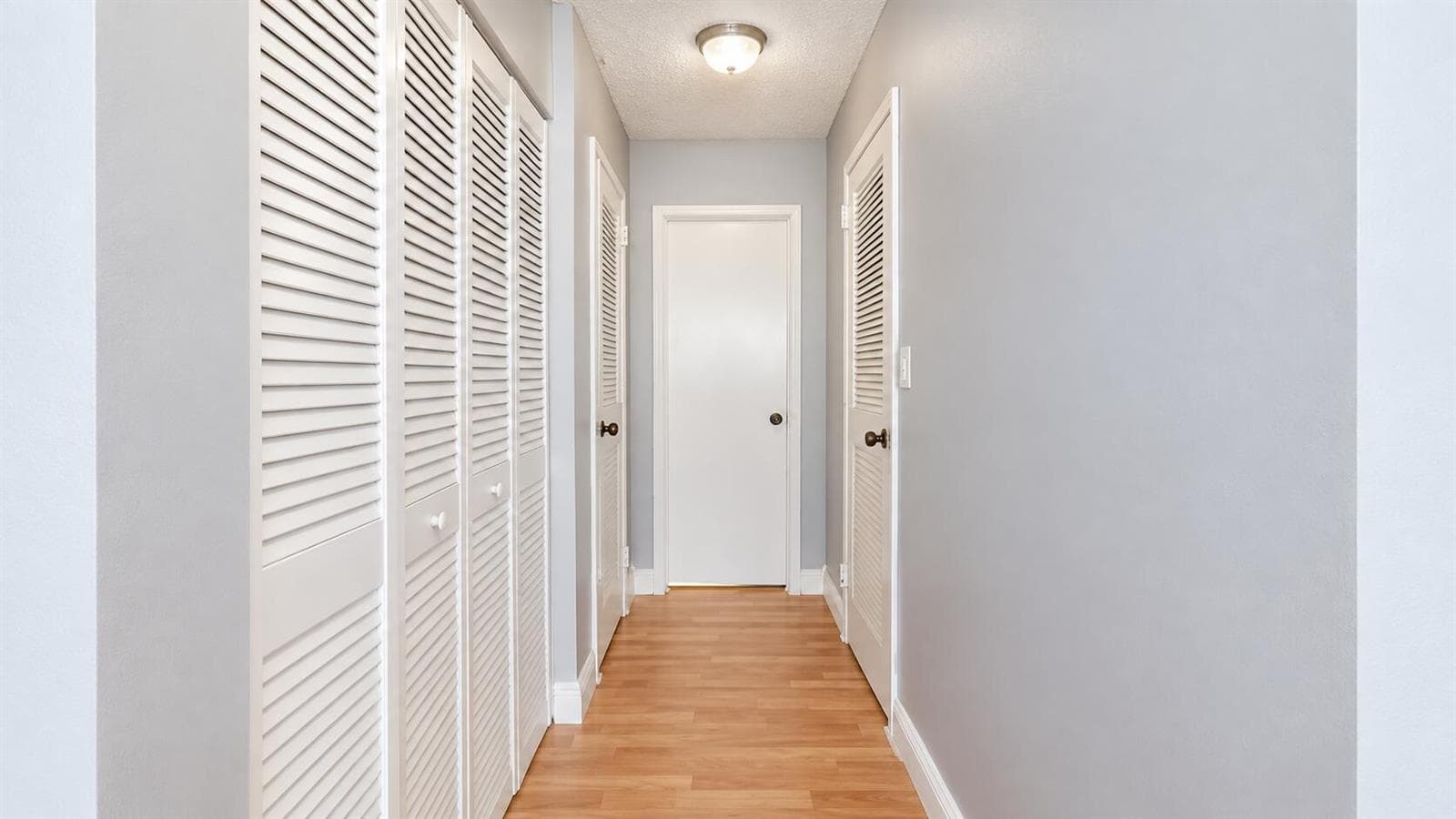 Bright Gray Hallway with Louvered Closet