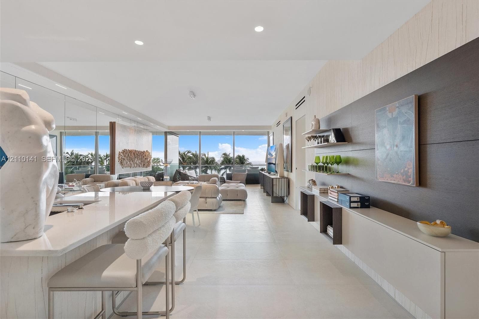 custom wall-mounted cabinetry, and a stone-surface waterfall edge island, kitchen was remodeled