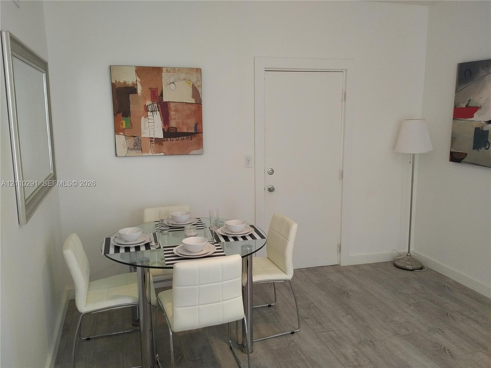 Wood-finish flooring and white interior wall paint