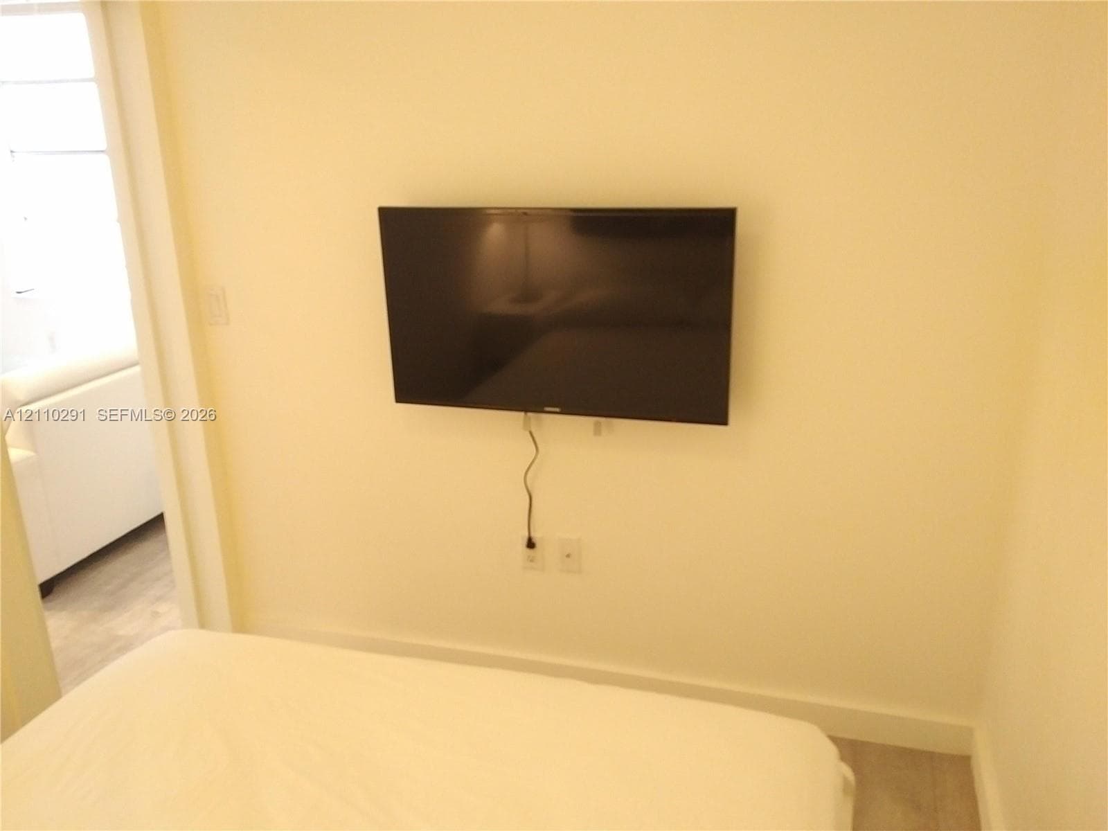 Wall-mounted television bracket with integrated electrical and data outlets