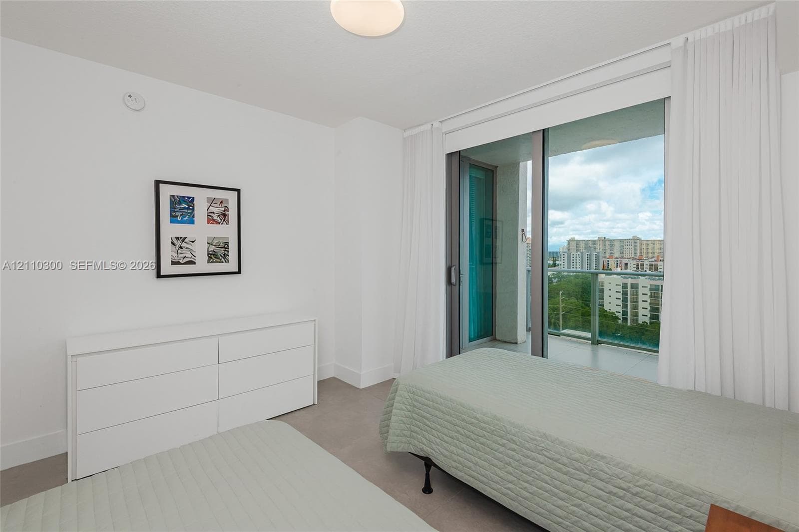 Bedroom 2. Neutral-toned wall-to-wall carpeting, crisp white walls, and a recessed closet with double doors