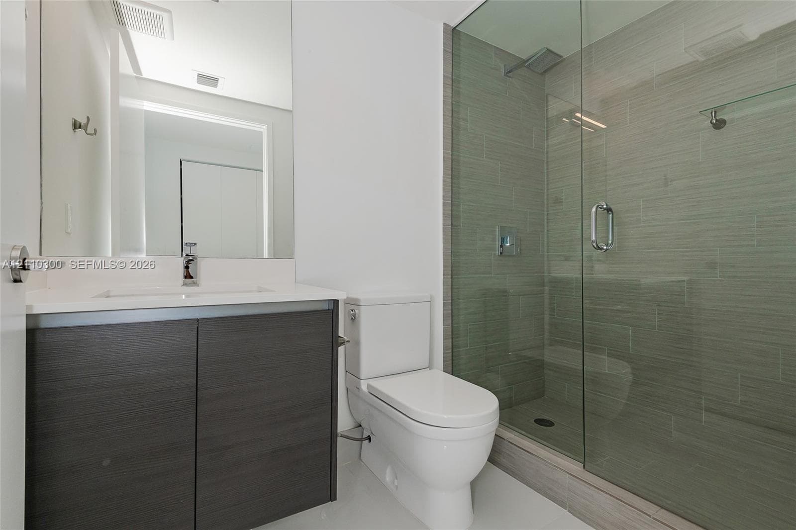 Bedroom 3. Floor-to-ceiling windows featuring metal framing, flush-mount overhead lighting, and neutral-tone flooring