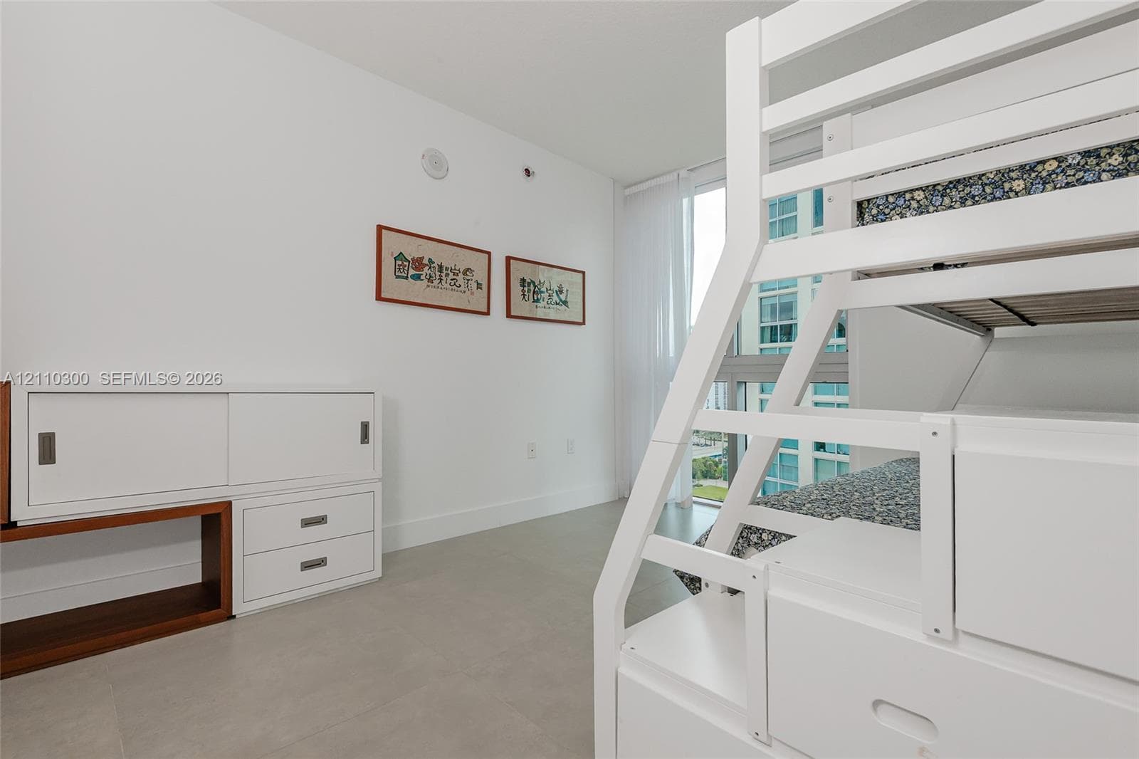 Bedroom 3. Interior space featuring light-toned tile flooring, recessed ceiling lighting, and double-door closet storage