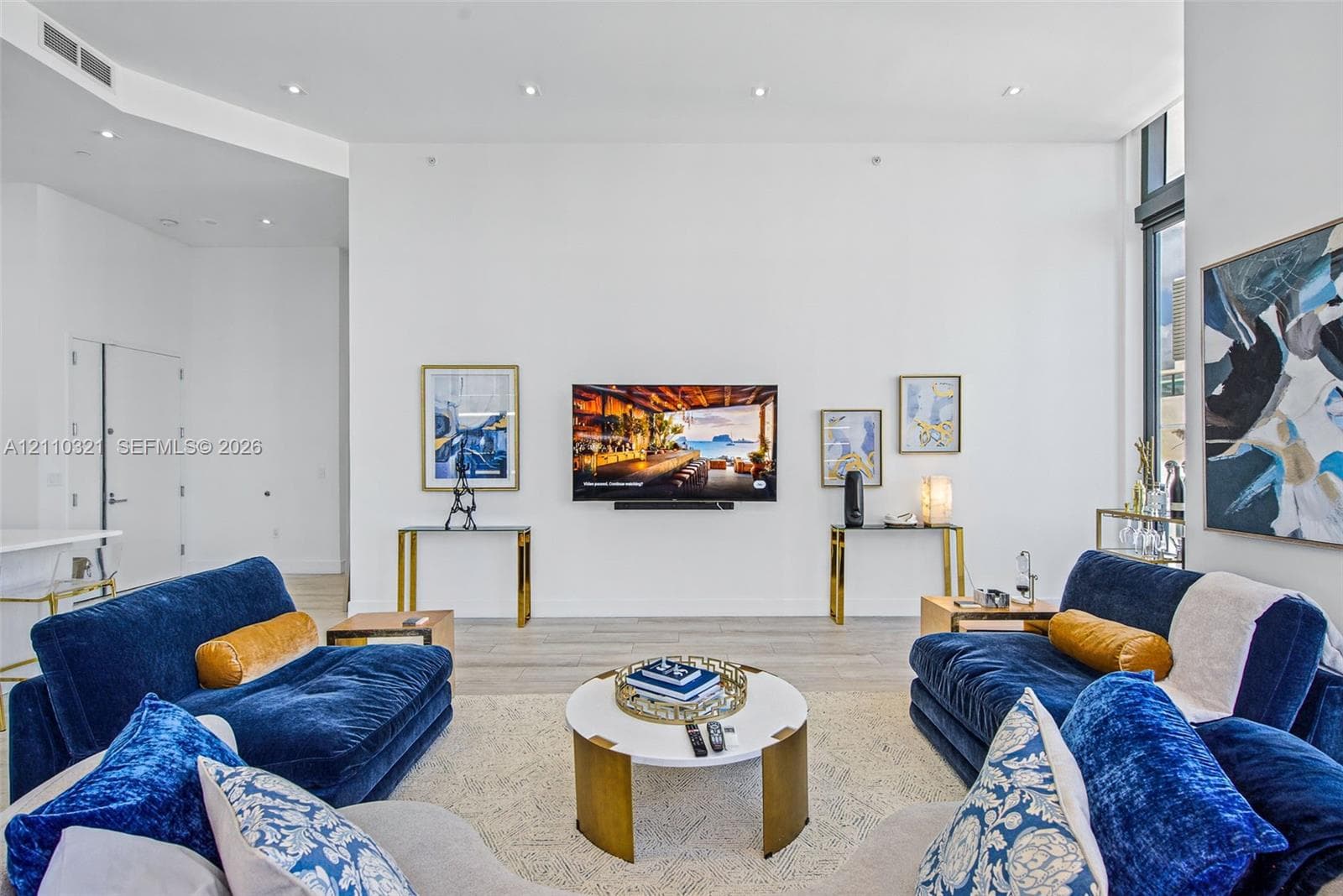 High ceilings, wood-finish flooring, recessed lighting, and floor-to-ceiling windows
