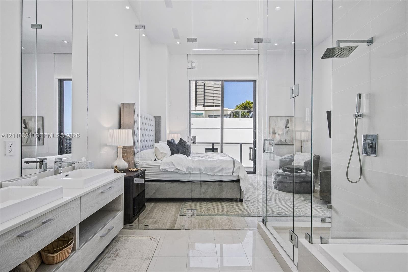 Dual vanity with rectangular vessel sinks, floor-to-ceiling glass-enclosed shower, polished stone flooring, and recessed ceiling lighting