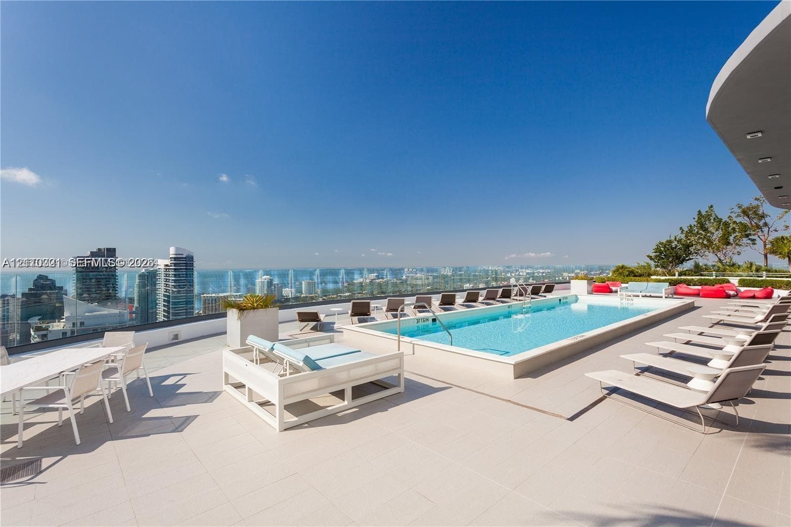 Rooftop terrace featuring an elevated swimming pool, large-format tile flooring, and a glass perimeter railing