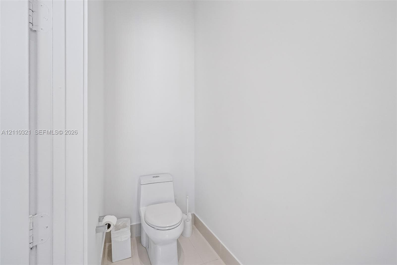 One-piece dual-flush toilet featuring a sleek, skirted base and neutral tile flooring