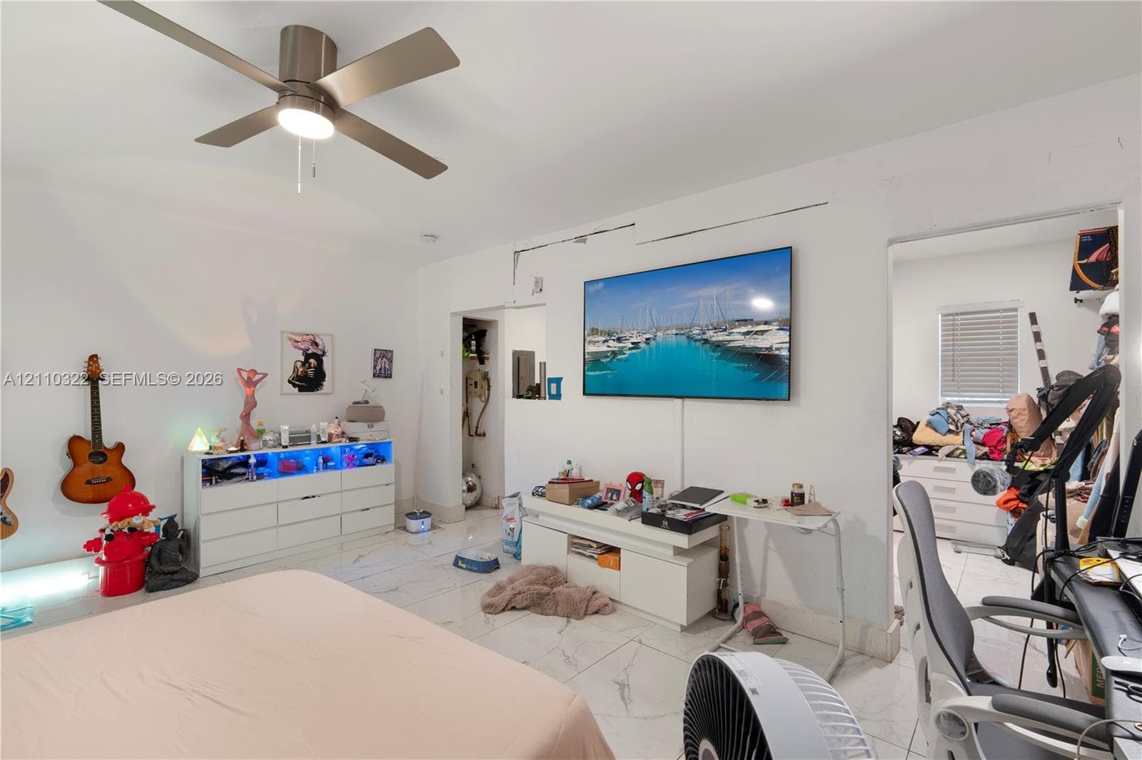 Large-format tile flooring and a ceiling fan with integrated lighting