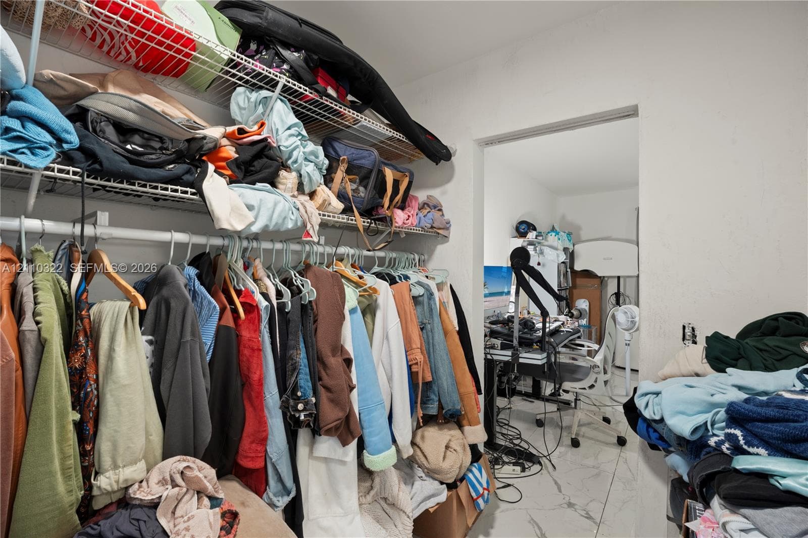 Storage area featuring white wire shelving and tile flooring