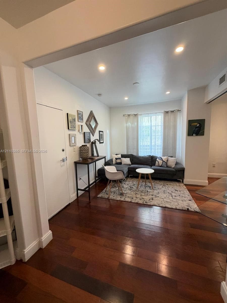 Wood-finish flooring, recessed lighting, and large window with natural light
