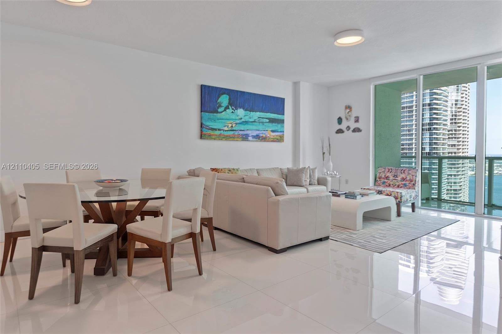 Polished porcelain tile flooring, floor-to-ceiling glass sliding doors, and recessed ceiling lighting