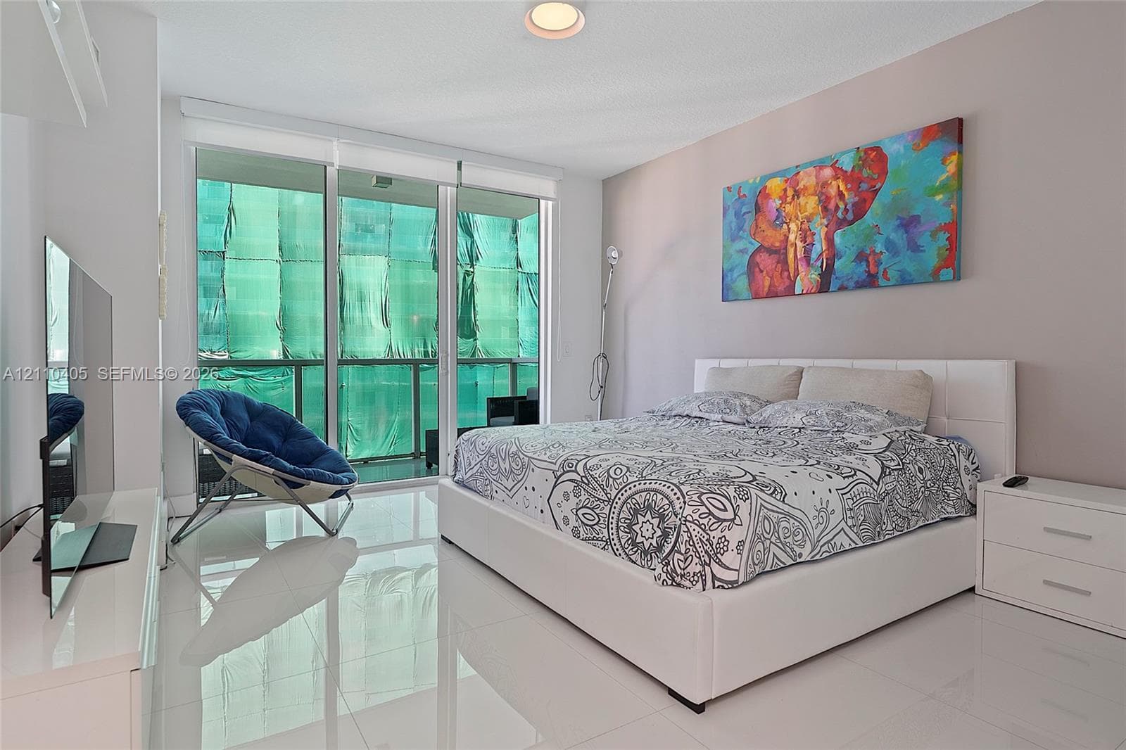Floor-to-ceiling glass panel door, polished tile flooring, and recessed ceiling lighting