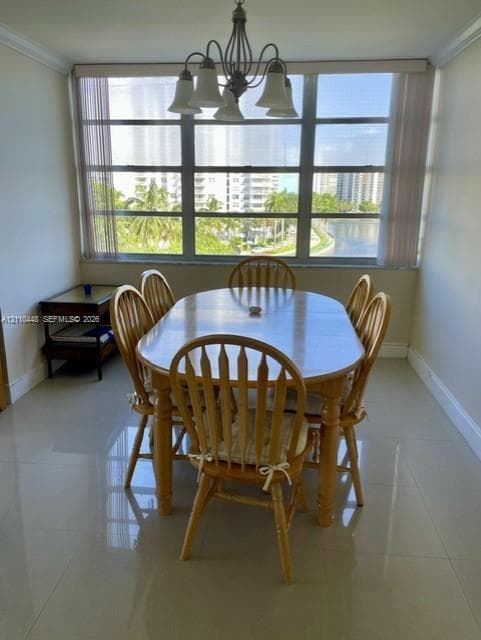 Large window featuring a metal frame, polished tile flooring, and an overhead multi-arm chandelier