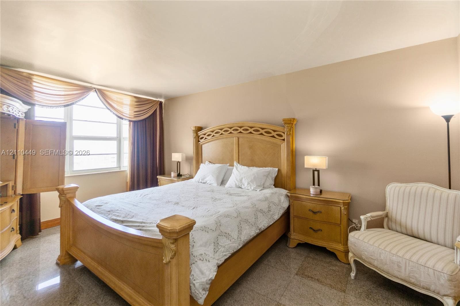 Large horizontal window with multi-pane configuration, polished stone-finish flooring, and neutral wall tones