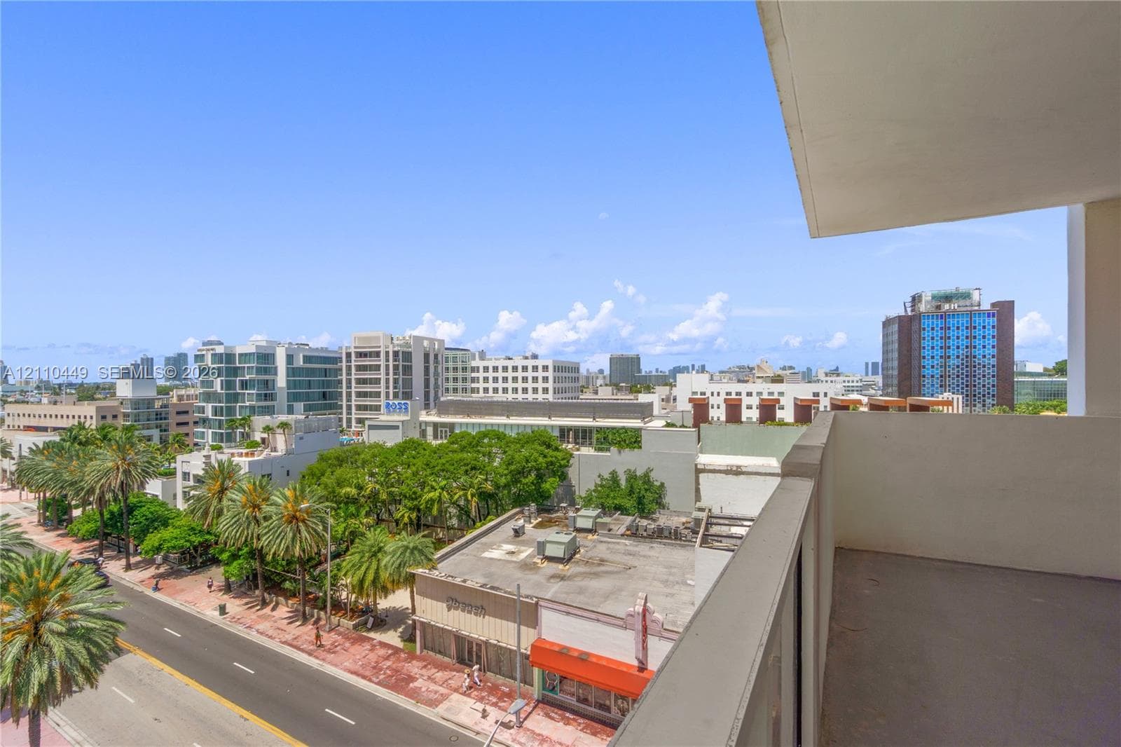 Private balcony featuring a concrete floor and perimeter railing with urban cityscape panoramas