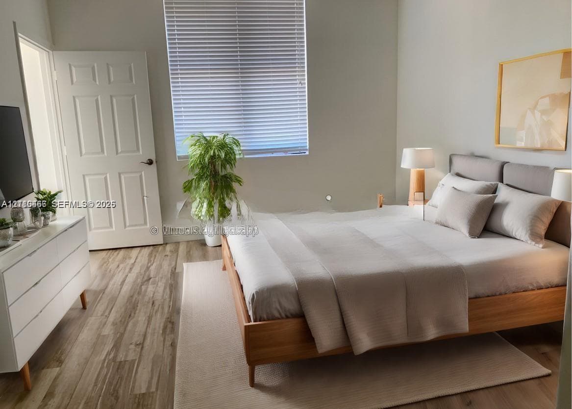 Wood-finish flooring, neutral wall tones, and horizontal window blinds