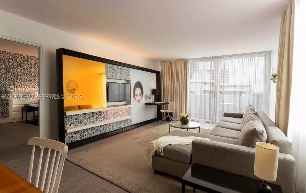 Custom floor-to-ceiling media console with integrated patterned tiling, inset shelving, and a wall-mounted desk