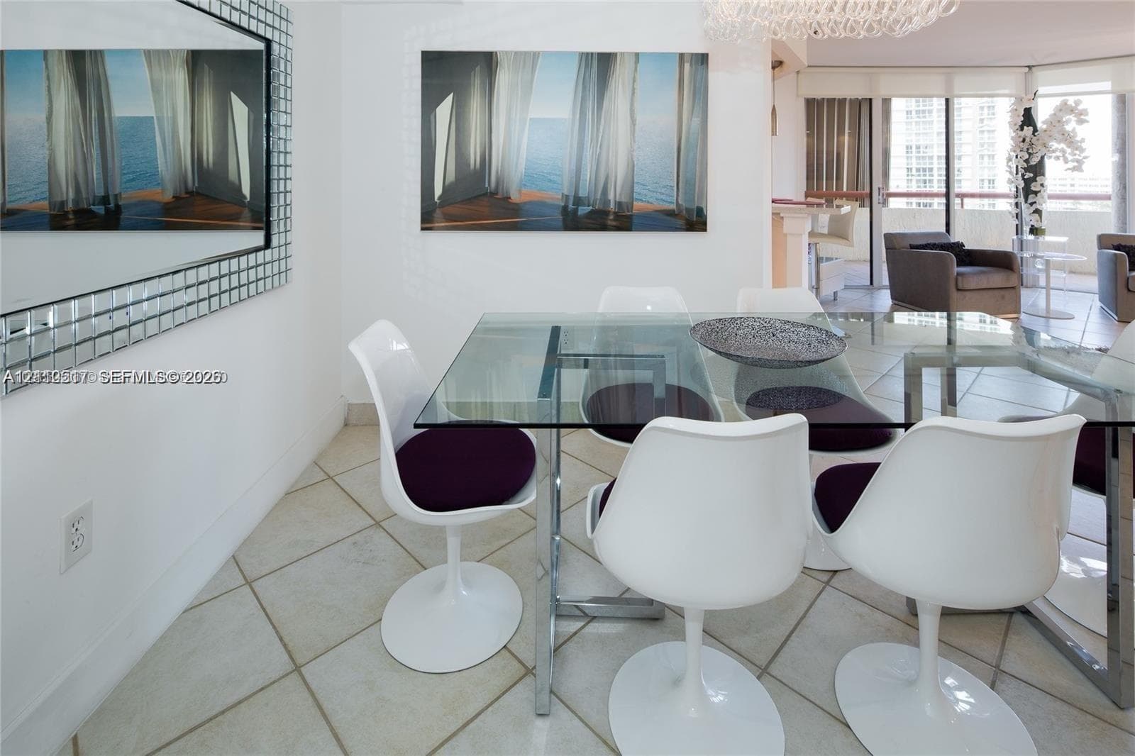 Large-format grid mirror with a metallic frame, expansive glass-paned sliding doors, polished tile flooring, and a contemporary crystal chandelier