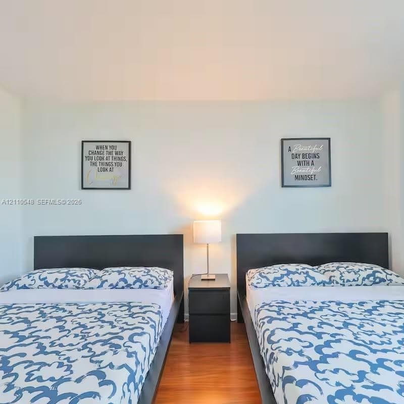 Room featuring smooth-finish walls and wood-finish flooring