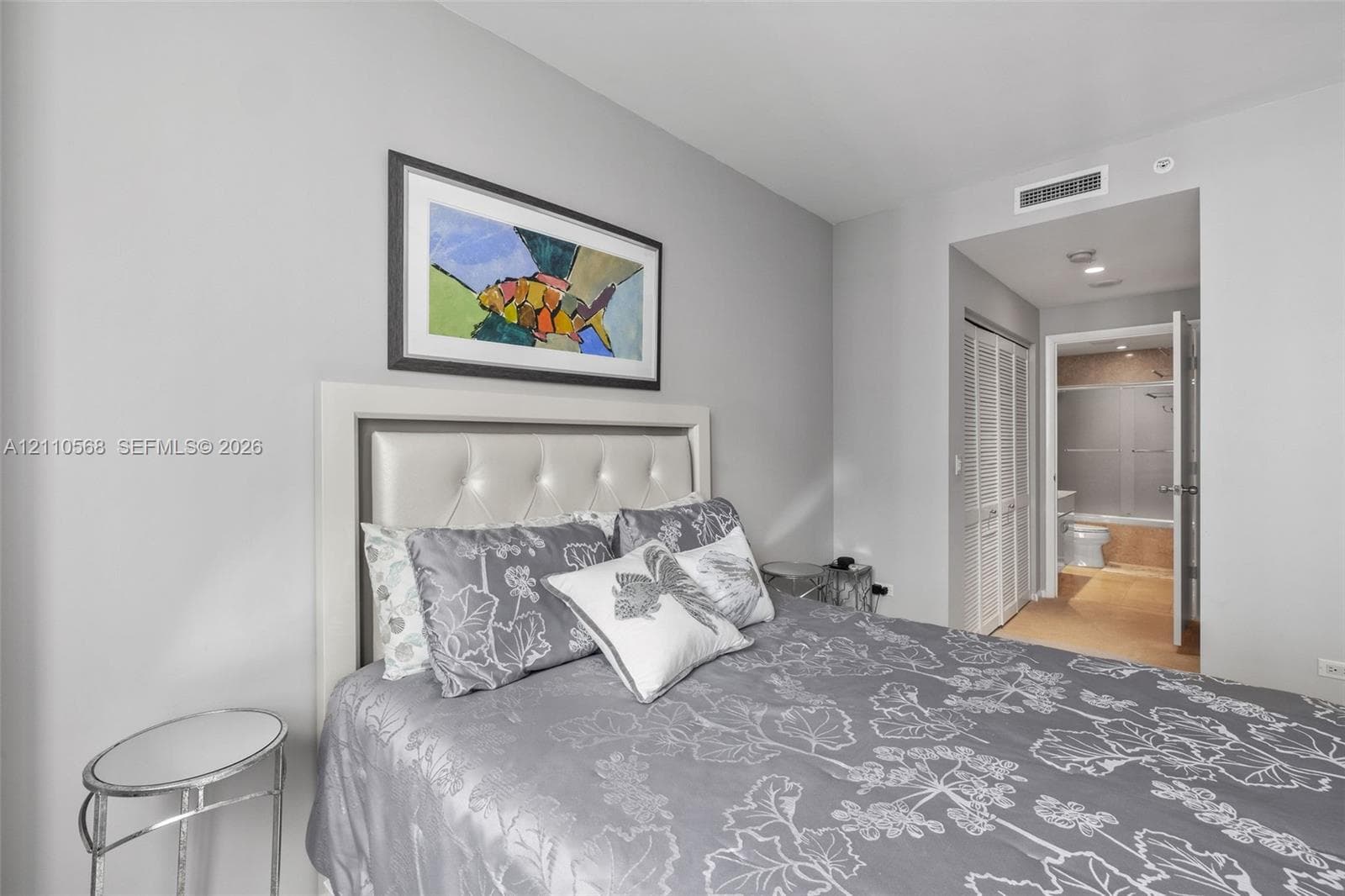 Neutral-toned walls with louvered closet doors