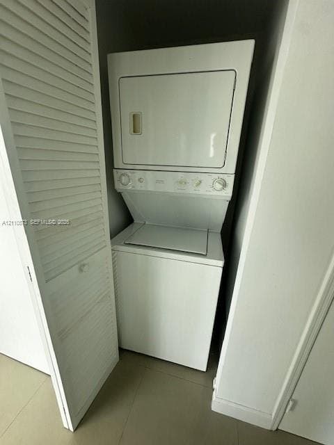 Stacked laundry unit featuring white enamel finish, enclosed by louvered bi-fold doors