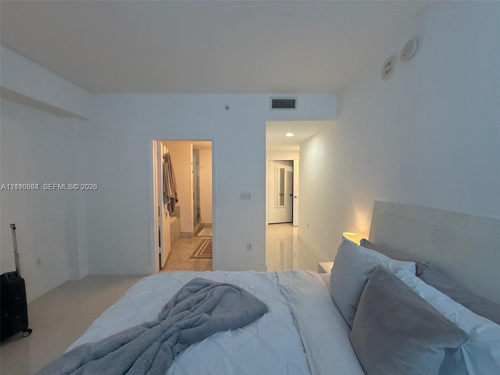 Interior space with neutral paint, light-colored tile flooring, recessed ceiling lighting, and a doorway entry