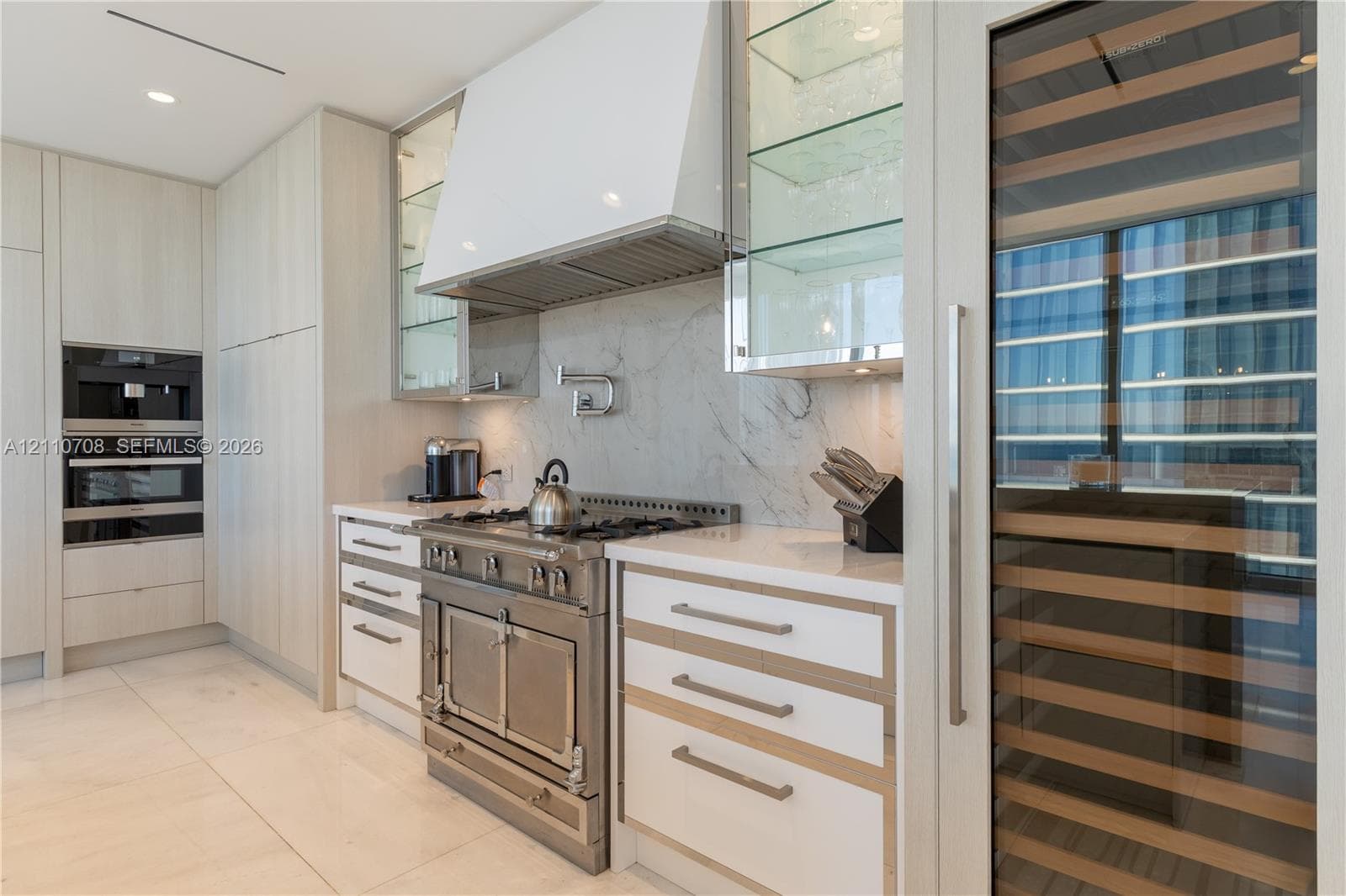 Built-in multi-tiered shelving with a matte finish, recessed lighting, and herringbone-patterned flooring