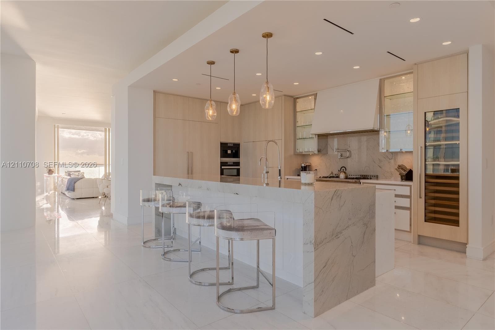 Custom sculptural wall molding with integrated circular niches, tiered curved wood-finish shelving, recessed accent lighting, and cloud-patterned ceiling fixtures