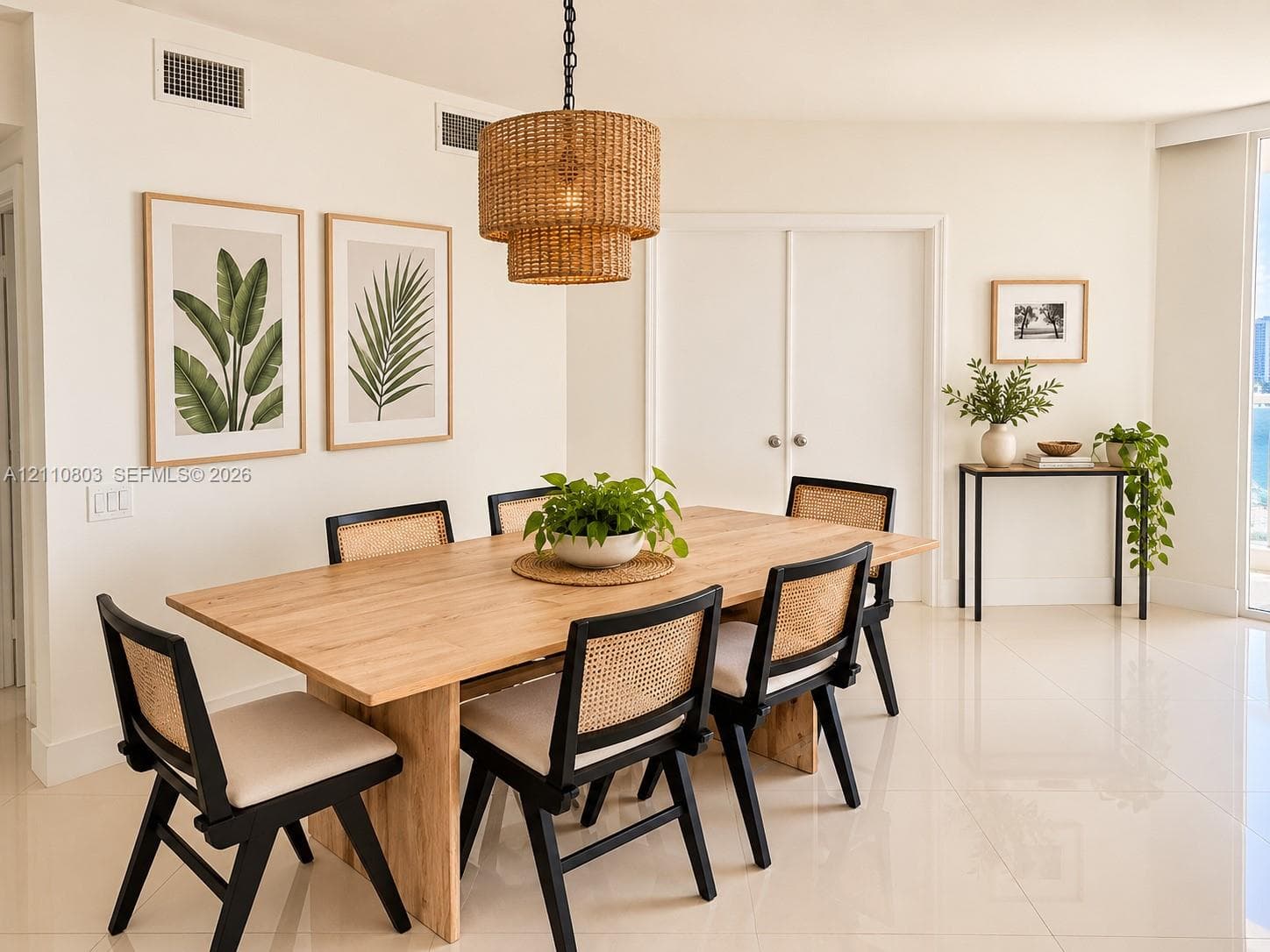 Dining area featuring polished large-format tile flooring and a multi-tiered woven pendant light fixture