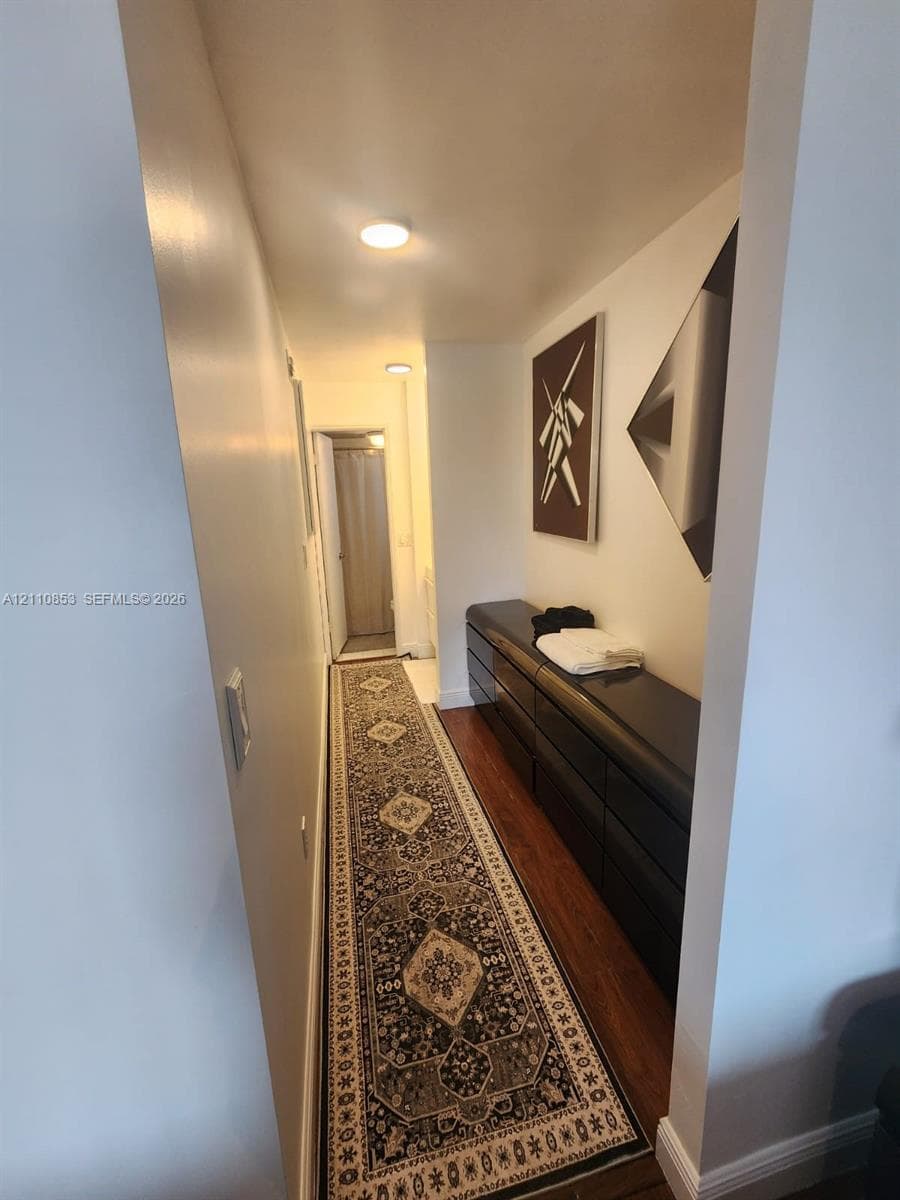 Hallway featuring wood-finish flooring and recessed lighting